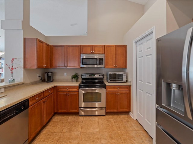 kitchen featuring light tile patterned floors and appliances with stainless steel finishes