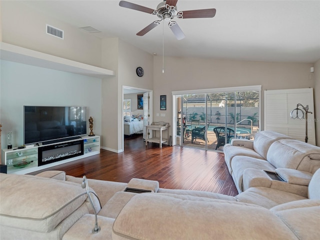 living room featuring ceiling fan, lofted ceiling, and dark hardwood / wood-style flooring