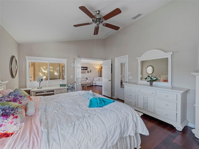 bedroom with lofted ceiling, dark hardwood / wood-style flooring, and ceiling fan