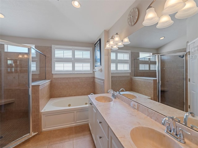 bathroom with tile patterned flooring, shower with separate bathtub, lofted ceiling, and vanity