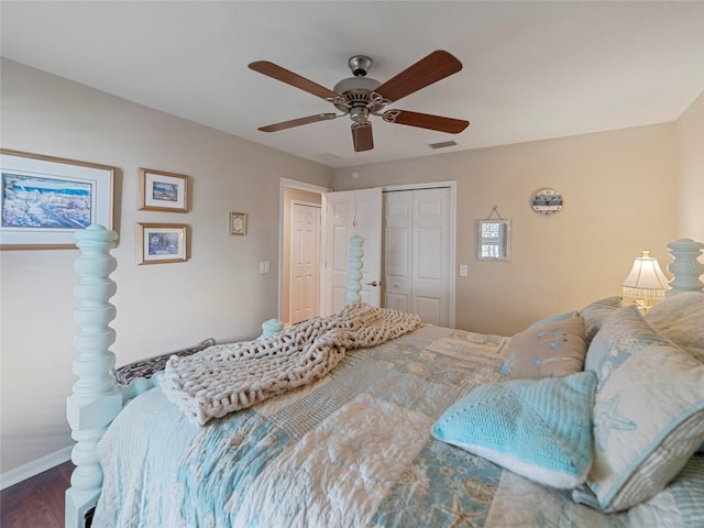 bedroom featuring dark hardwood / wood-style flooring, a closet, and ceiling fan