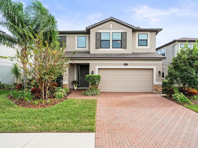 view of front of house featuring a front yard and a garage