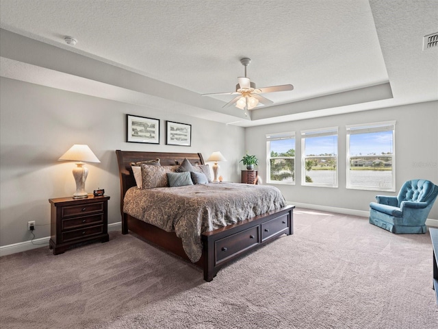 bedroom with carpet flooring, ceiling fan, and a textured ceiling