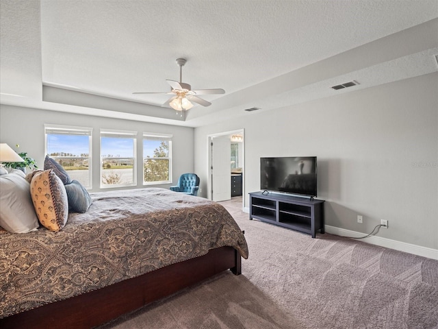 carpeted bedroom featuring a textured ceiling, ensuite bathroom, and ceiling fan