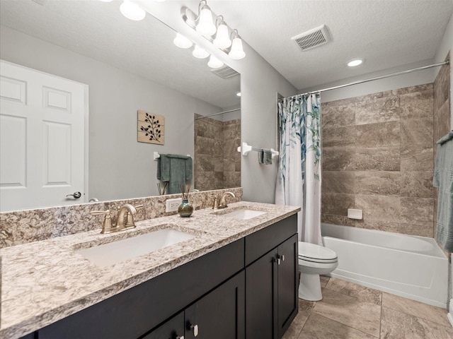 full bathroom with vanity, shower / tub combo, a textured ceiling, and toilet