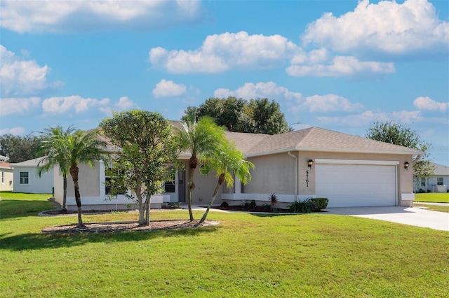 single story home with a garage and a front lawn