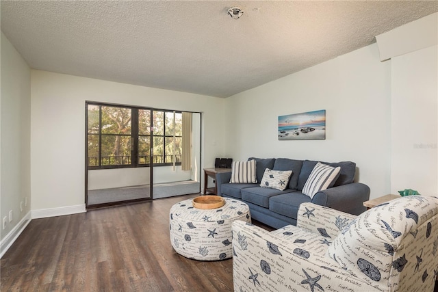 living room with dark wood-type flooring and a textured ceiling