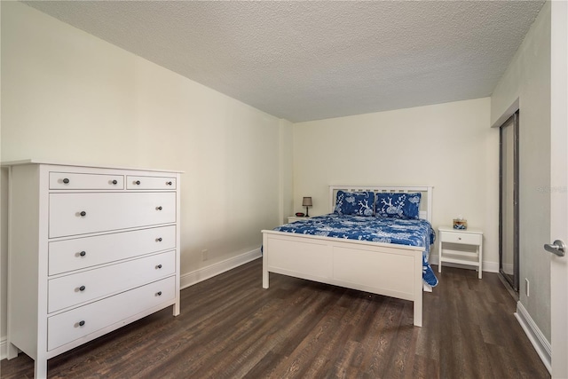 206 Tarpon Pt, Tarpon Springs, FL 34689 - bedroom with dark wood-style flooring, baseboards, and a textured ceiling