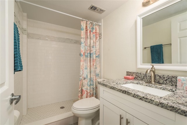 bathroom featuring vanity, toilet, and walk in shower