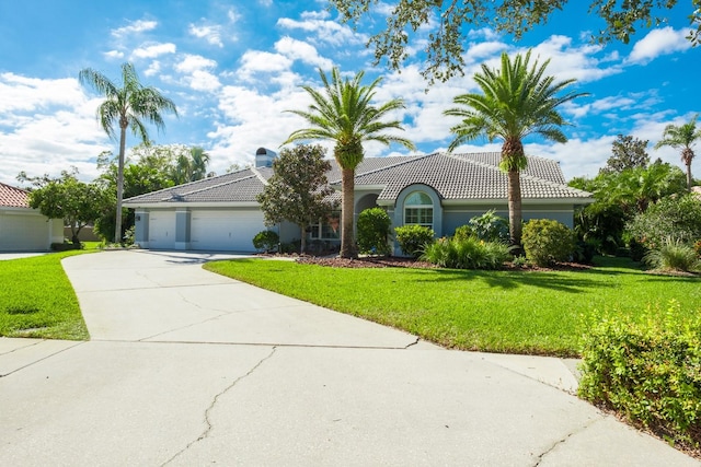 view of front facade featuring a front yard and a garage