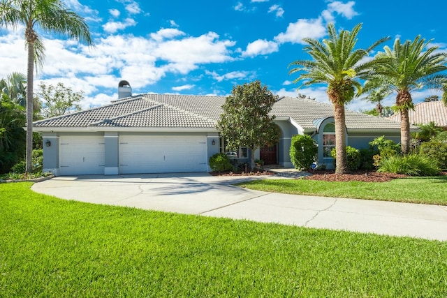 view of front of property featuring a garage and a front yard