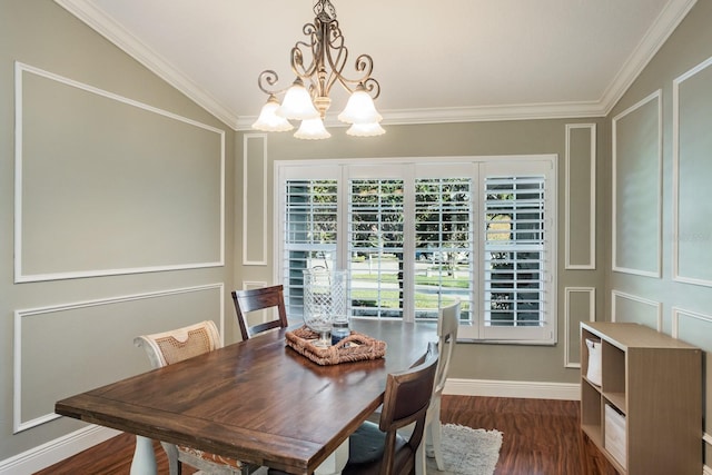 dining area featuring dark hardwood / wood-style floors, lofted ceiling, ornamental molding, and a chandelier