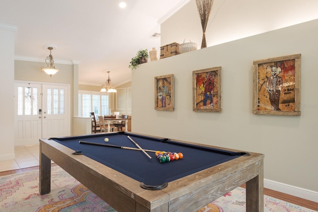 recreation room featuring french doors, crown molding, light hardwood / wood-style flooring, a chandelier, and pool table