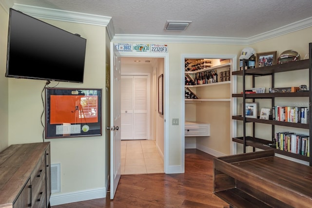 interior space with crown molding, dark hardwood / wood-style flooring, and a textured ceiling