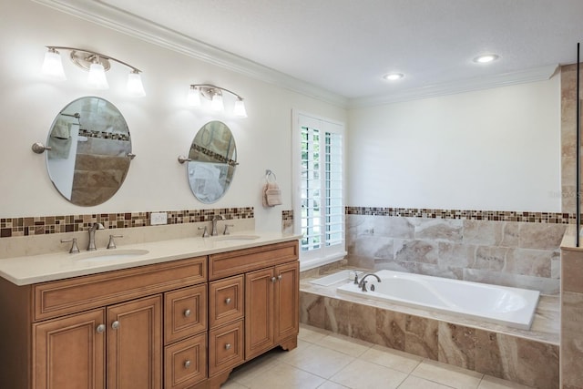 bathroom with vanity, tile patterned floors, ornamental molding, and tiled tub