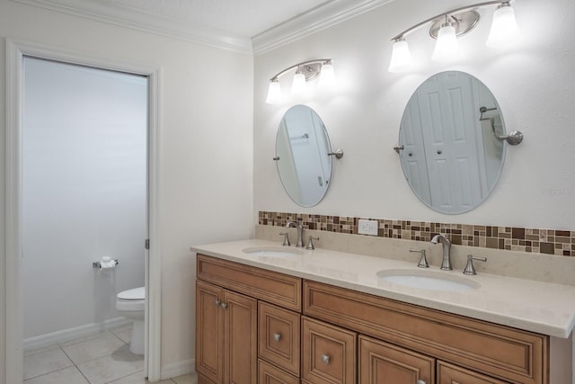 bathroom featuring backsplash, tile patterned floors, crown molding, toilet, and vanity