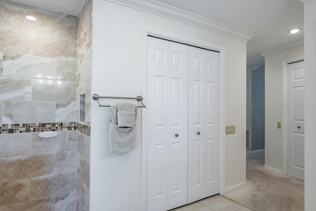 bathroom with tiled shower, tile patterned floors, and ornamental molding