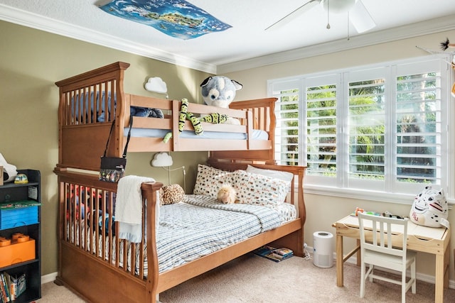 carpeted bedroom with ceiling fan and ornamental molding