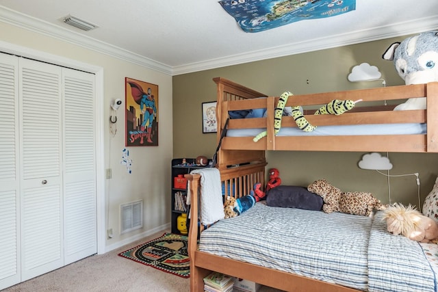 bedroom featuring carpet, crown molding, and a closet