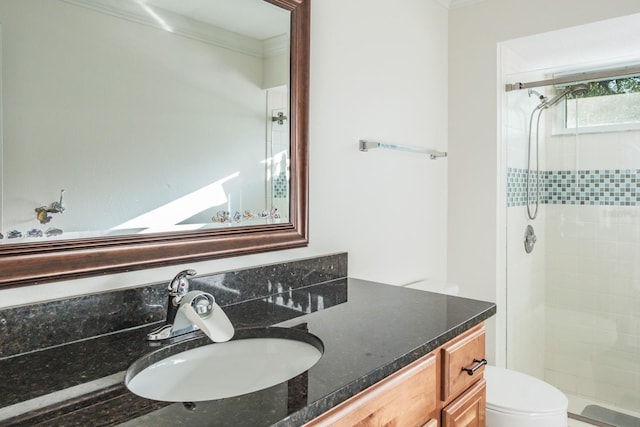 bathroom featuring vanity, toilet, an enclosed shower, and crown molding