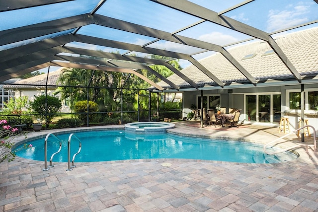 view of swimming pool with a lanai, a patio area, and an in ground hot tub