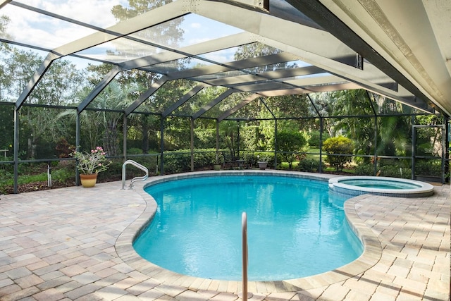 view of swimming pool with a patio area, a lanai, and an in ground hot tub