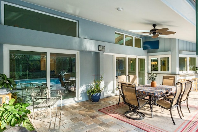 sunroom / solarium with ceiling fan and vaulted ceiling