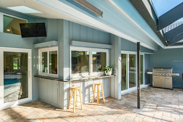 view of patio / terrace with a grill and exterior bar