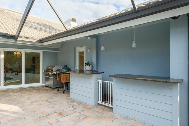 view of patio / terrace featuring area for grilling and a bar