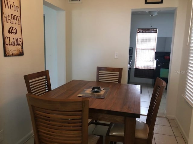 tiled dining area featuring ceiling fan