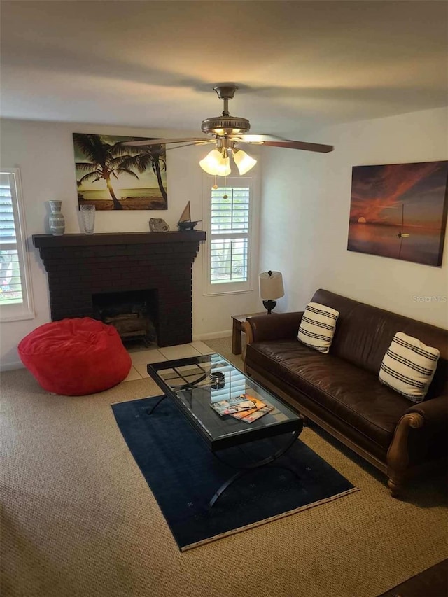 living room featuring a brick fireplace and ceiling fan