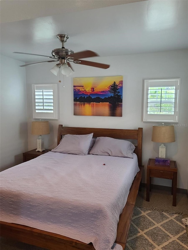 bedroom featuring ceiling fan and multiple windows