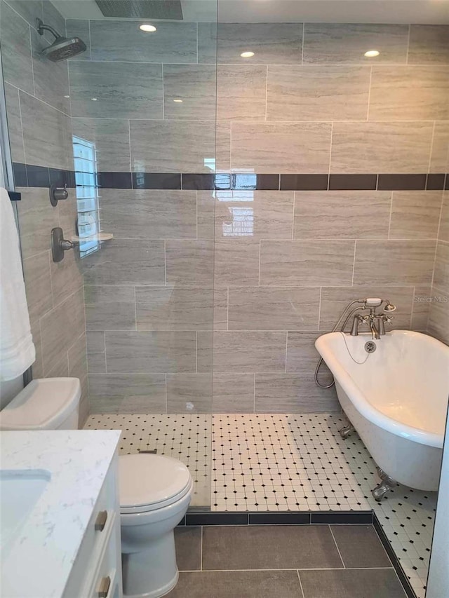 full bathroom with tile patterned floors, plus walk in shower, tile walls, and toilet