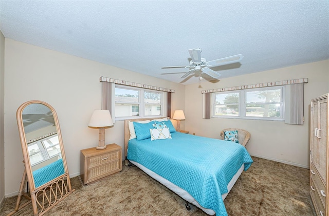 carpeted bedroom with a textured ceiling and ceiling fan