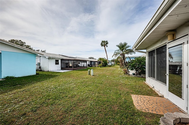 view of yard with a sunroom