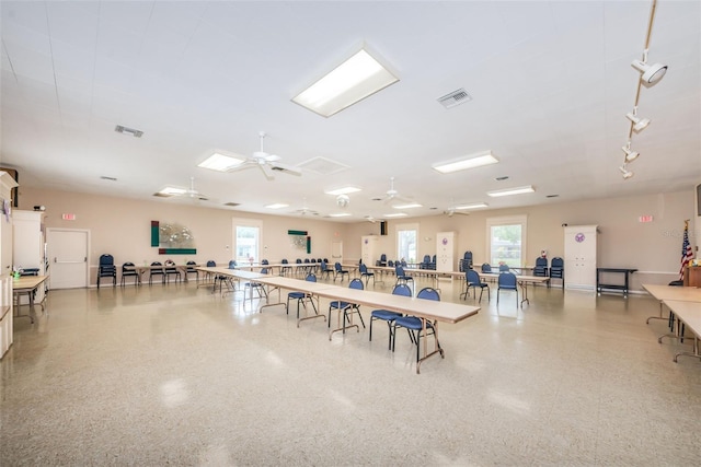 miscellaneous room with visible vents, a ceiling fan, and speckled floor