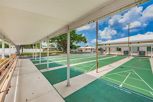 view of home's community featuring fence and shuffleboard