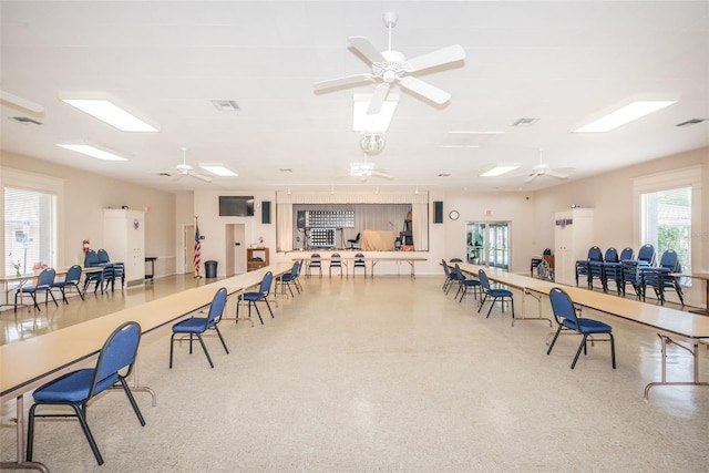 office space with visible vents and ceiling fan