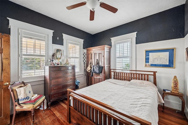 bedroom featuring dark hardwood / wood-style floors and ceiling fan