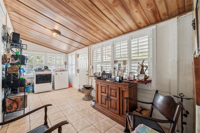 kitchen featuring washing machine and clothes dryer, light tile patterned floors, wooden ceiling, and vaulted ceiling