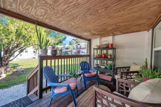 wooden deck with a lawn