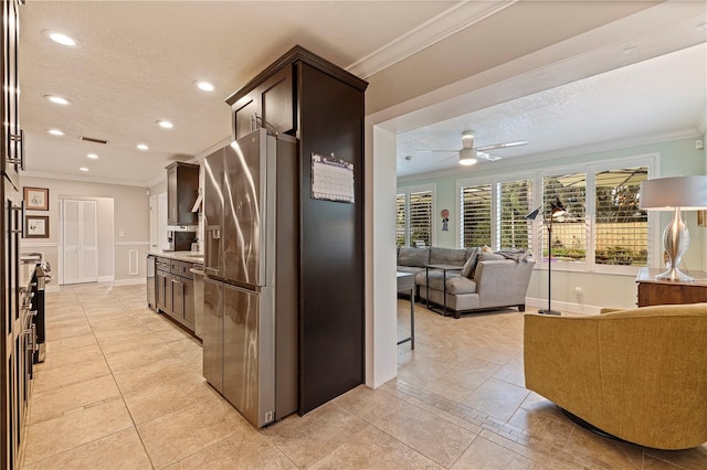 kitchen with stainless steel fridge, dark brown cabinets, a textured ceiling, ceiling fan, and crown molding