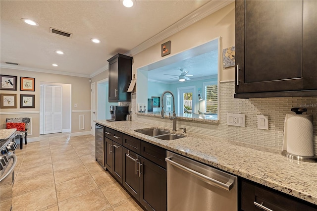 kitchen with ceiling fan, sink, stainless steel appliances, dark brown cabinets, and ornamental molding