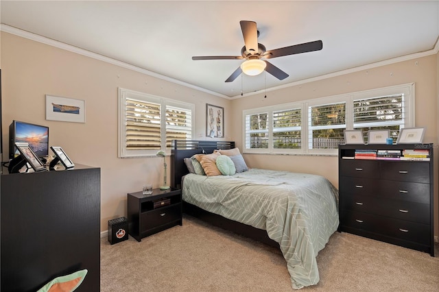 carpeted bedroom featuring ceiling fan and ornamental molding