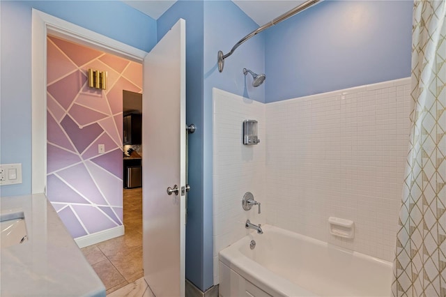 bathroom with tile patterned flooring, shower / bath combination with curtain, and tile walls