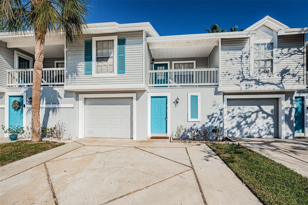 townhome / multi-family property featuring a balcony and a garage