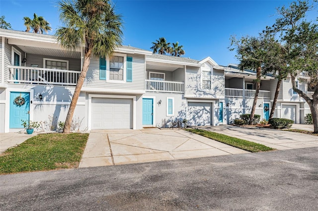 view of property with a garage and a balcony