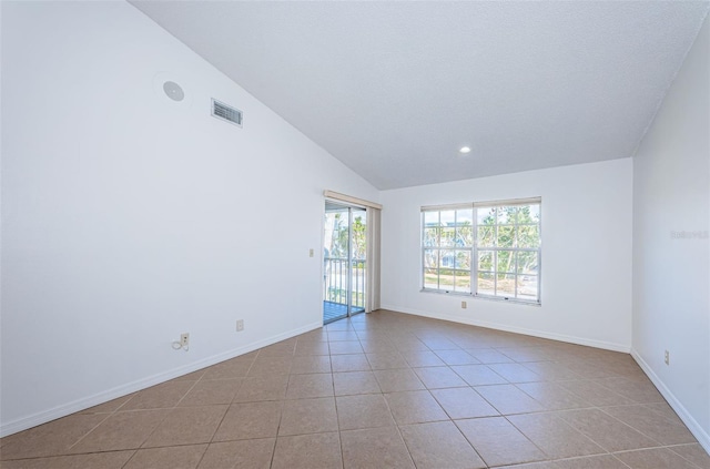 tiled empty room with vaulted ceiling