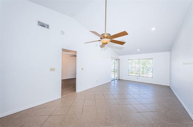 tiled spare room with ceiling fan and vaulted ceiling