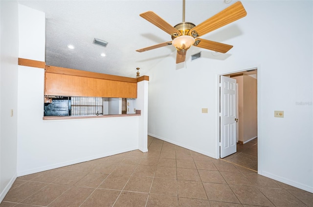 unfurnished living room featuring tile patterned floors and ceiling fan